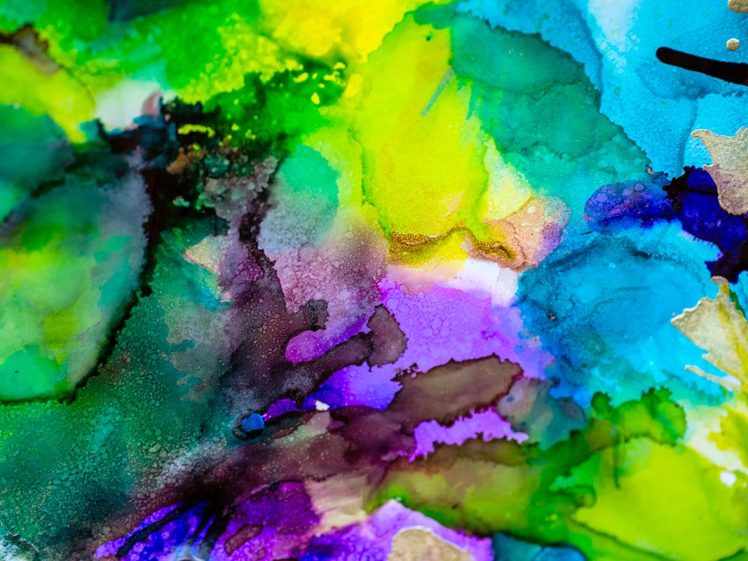 Image of Abstract watercolour painting featuring vibrant splashes of green, yellow, blue, purple, and hints of gold, blending and overlapping in a fluid, organic pattern.