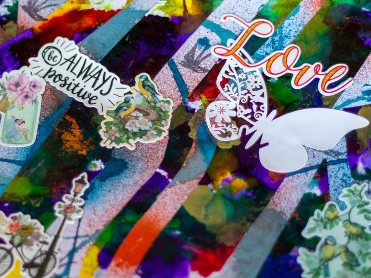 Image of Colourful abstract background with stickers featuring the words be always positive and Love, a butterfly, flowers, a bird, and a lamp-post, creating an uplifting and artistic collage.