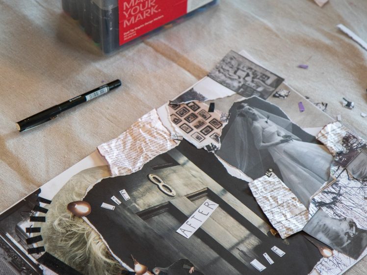Image of A collage made from torn black-and-white magazine clippings lies on a beige surface, surrounded by a black marker, a roll of tape, and a box of colourful markers.