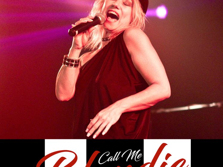 Image of A blonde woman in a black outfit and hat sings passionately into a microphone on stage with red lighting. Below her, the text Call Me Blondie is written in red script over black and white stripes.