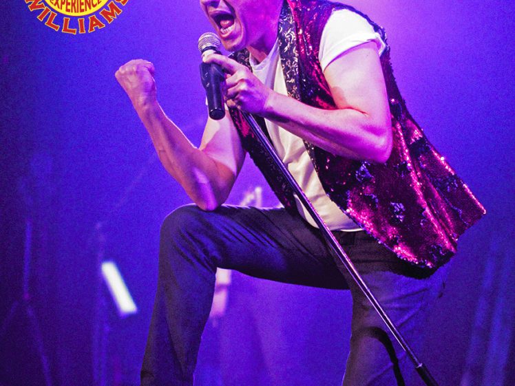 Image of A performer in a sequinned waistcoat passionately sings into a microphone on stage, with one fist raised. Bright purple lighting and The Robbie Williams Experience logo are visible in the background.